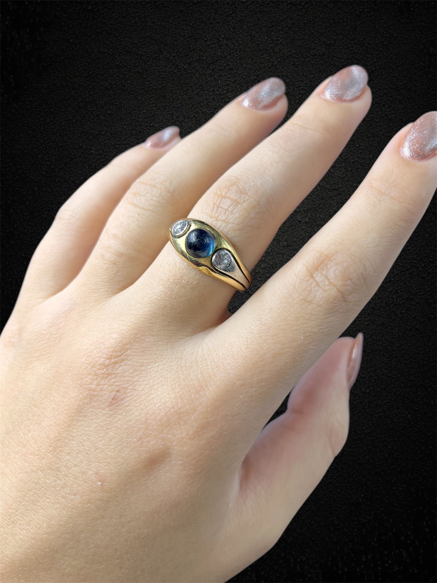 Anello a fascia in oro bianco con zaffiro cabochon e diamanti